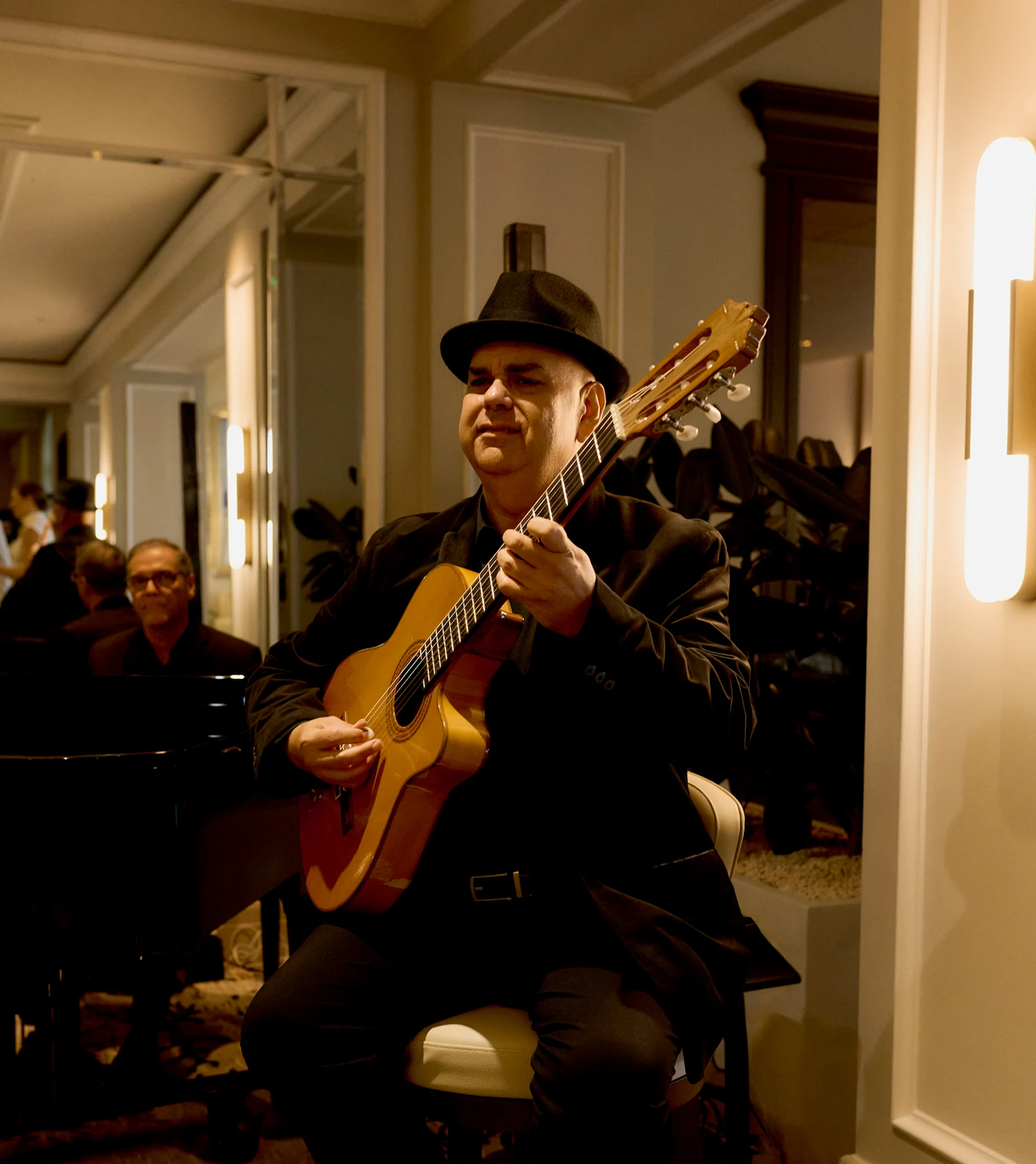 Live guitar and piano performance in a warmly lit lounge, creating a refined and intimate atmosphere