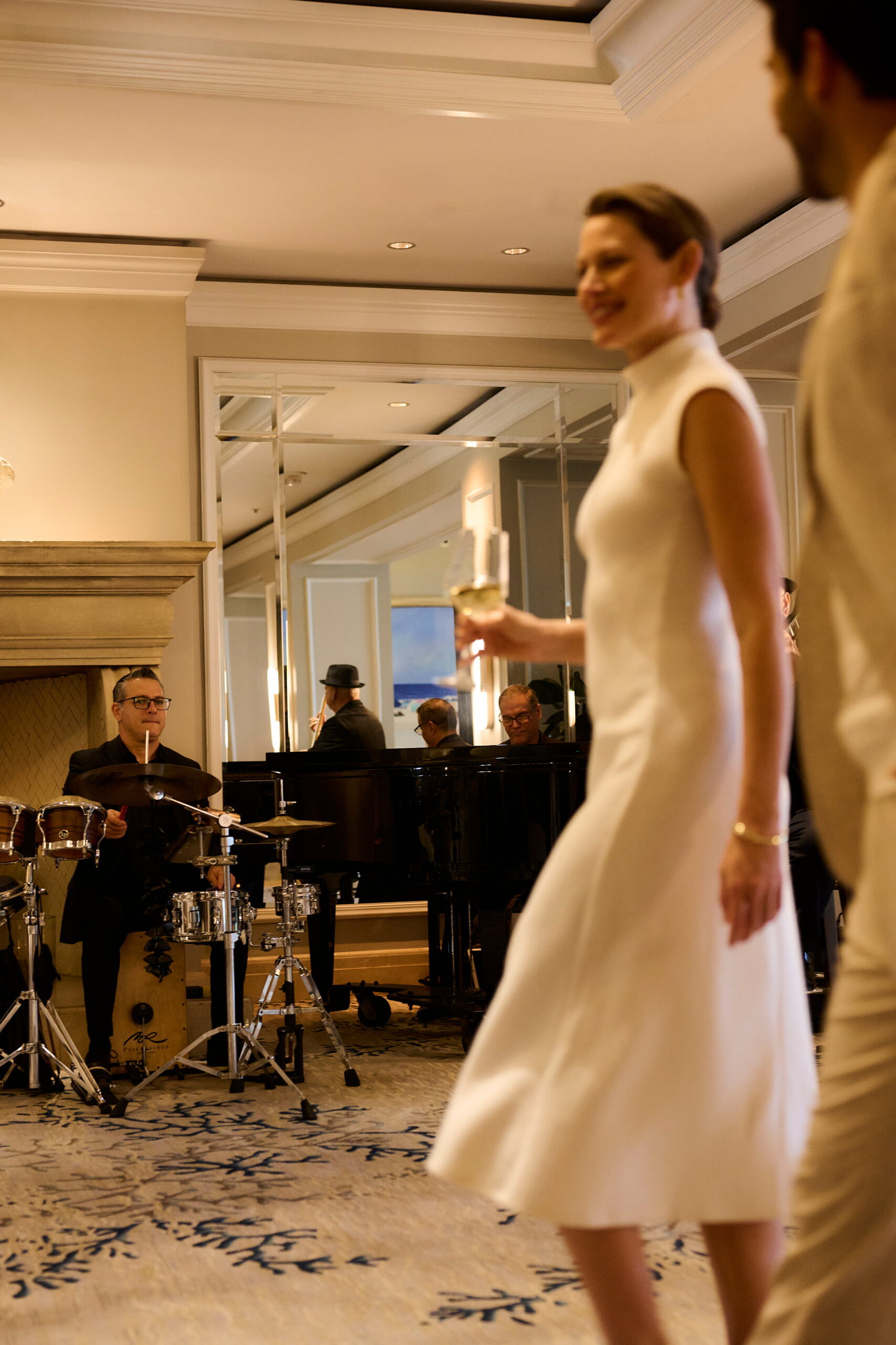 Couple enjoying live music indoors as drummer and pianist perform in elegant setting